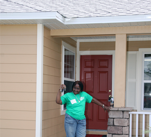 habitiat for humanity homeowner partner showing off keys to new home